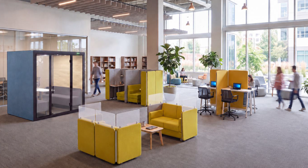 Integrated workplace solution with acoustic pods, adaptable seating, and open workstations